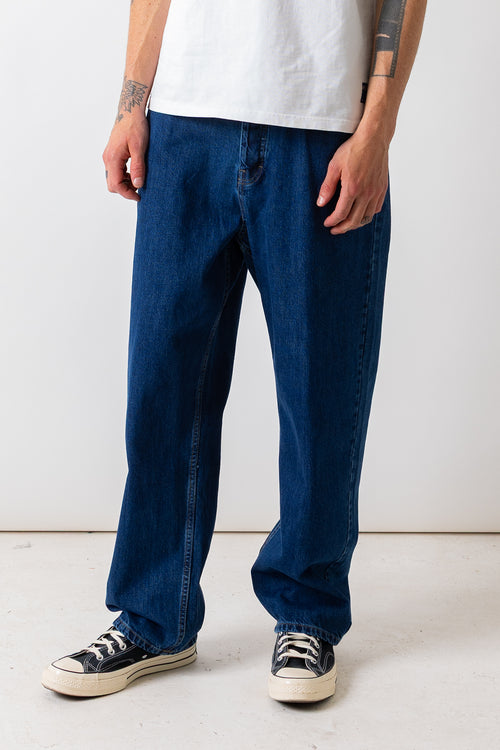 Close front view of a model wearing the Pexwear 5 Pocket Jean in Mid Blue.