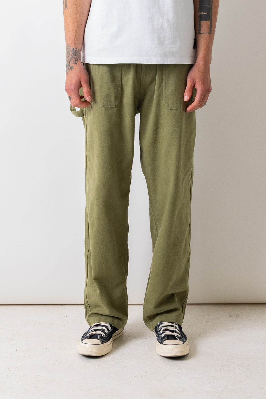 Close front view of a model wearing the Pexwear Tradesman Trouser in Khaki.