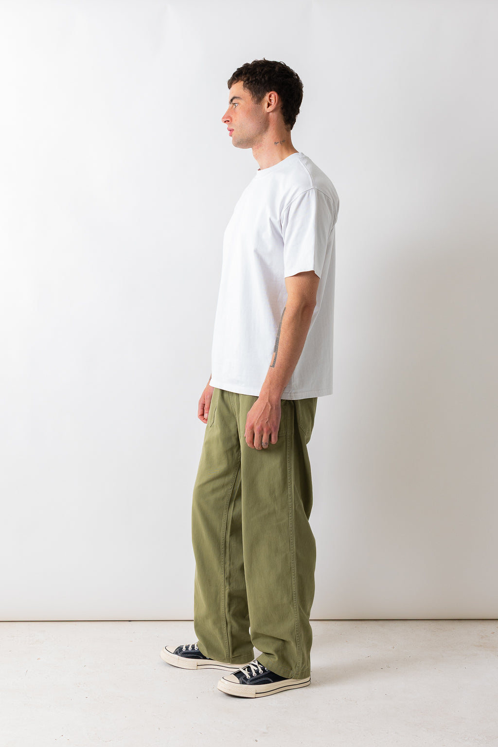 Full-length side view of a model wearing the Pexwear Tradesman Trouser in Khaki.