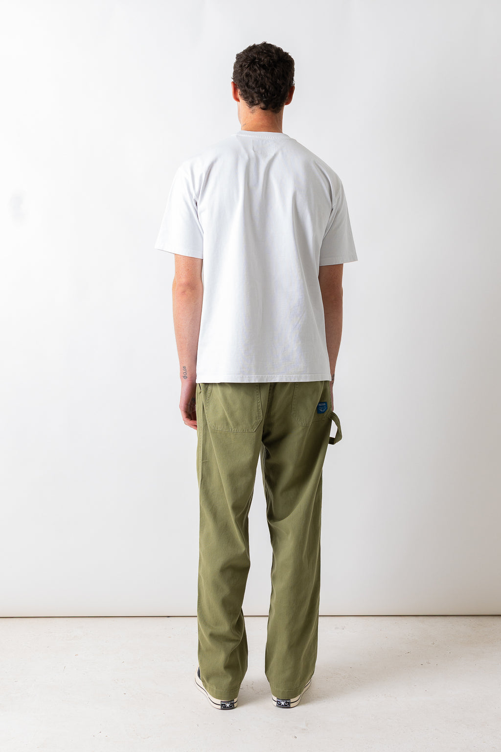 Full-length rear view of a model wearing the Pexwear Tradesman Trouser in Khaki.
