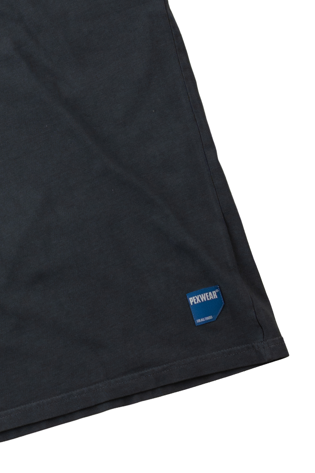 Close-up of a black fabric garment corner with a blue and white PEXWEAR logo patch near the hem, shown on a white background.