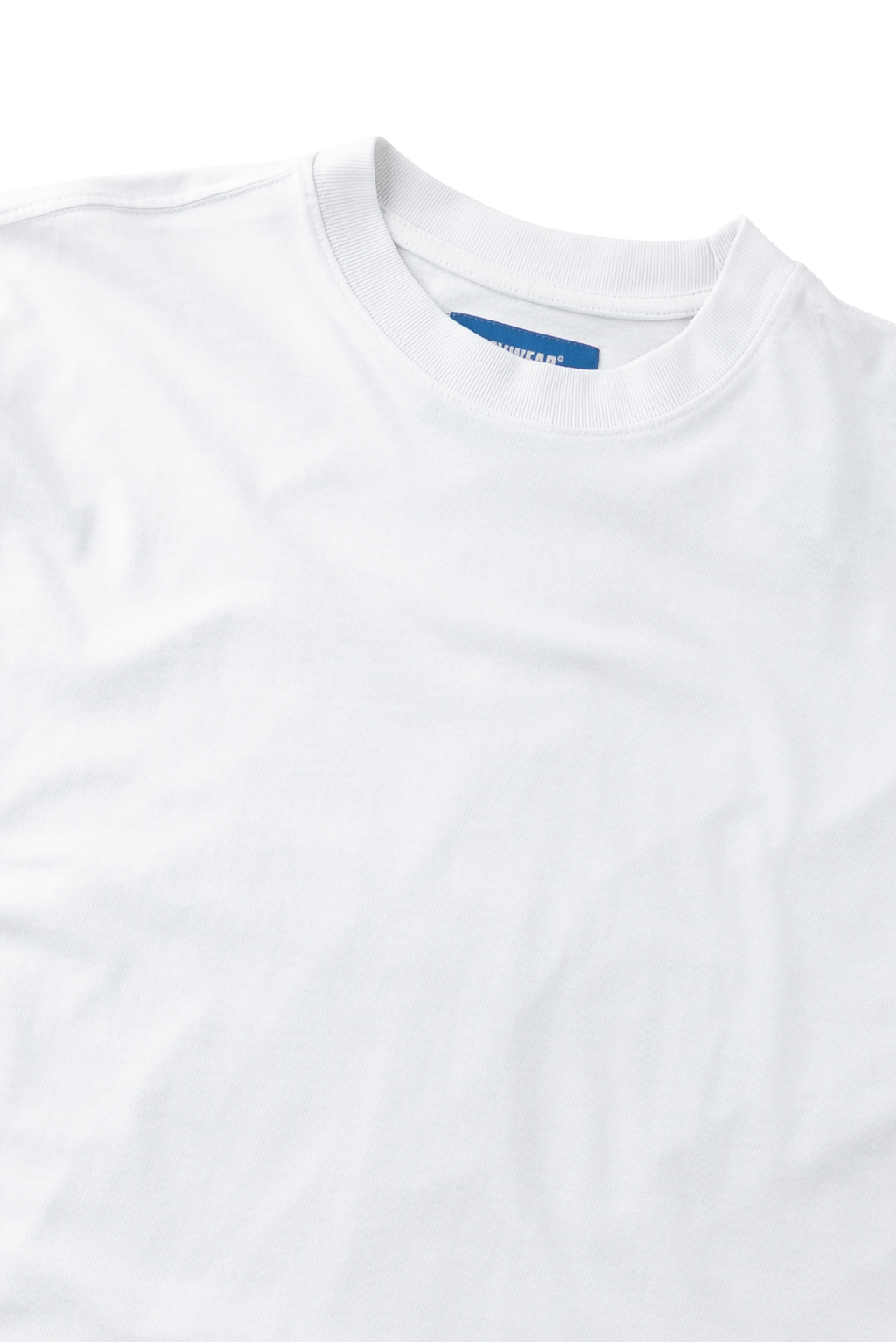 A close-up of a white crewneck t-shirt showing the inner collar label which reads 'GILDAN'.