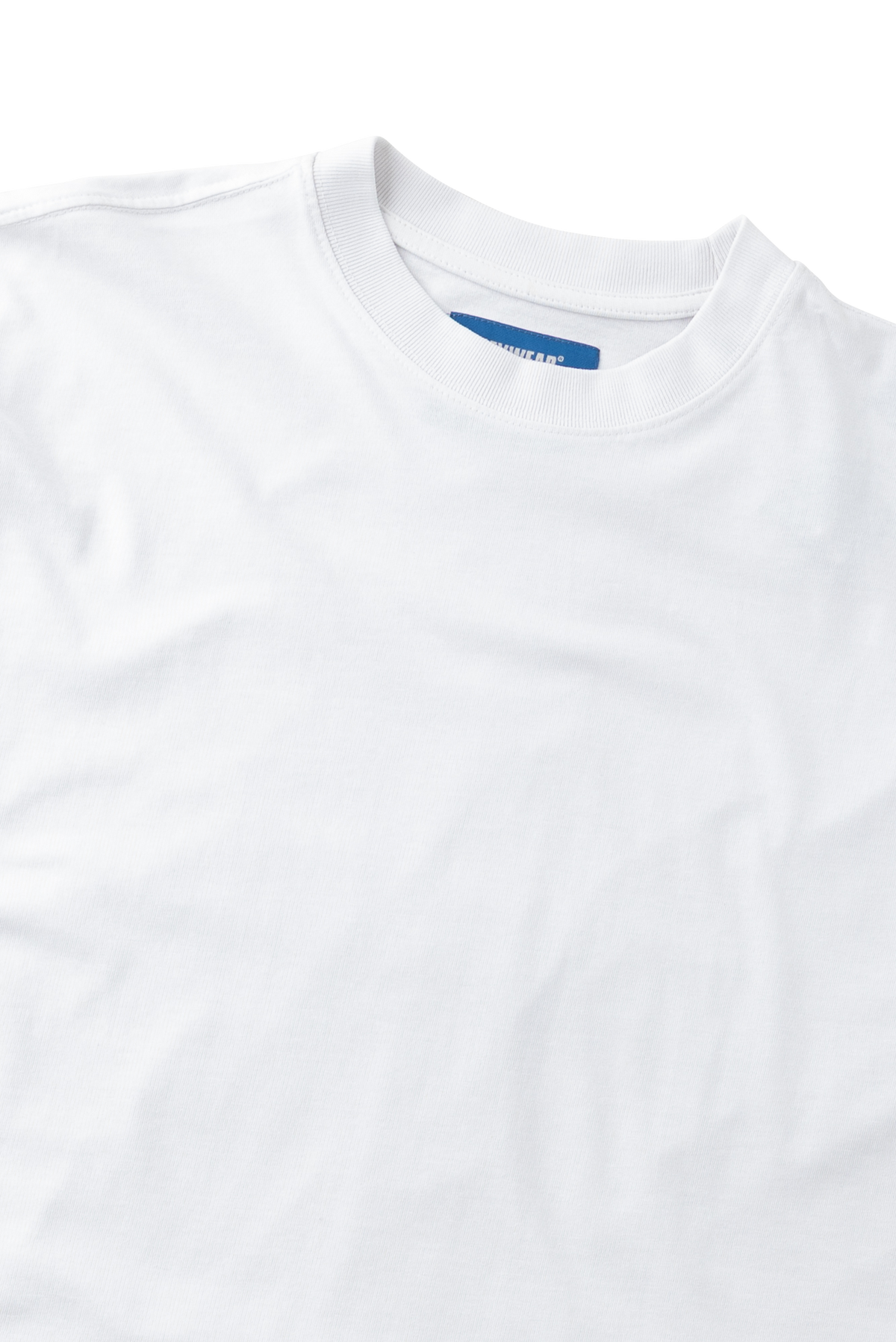 A close-up of a white crewneck t-shirt showing the inner collar label which reads 'GILDAN'.