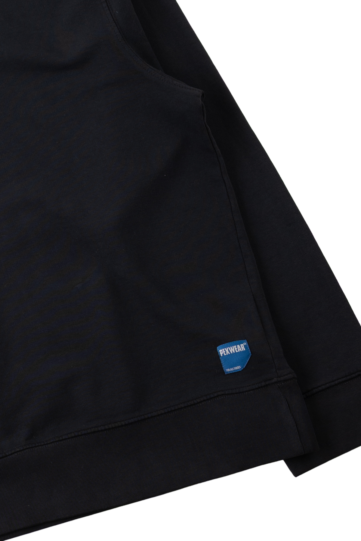 Close-up of a black garment sleeve or cuff with a small blue sewn label reading REVOLVE, shown against a white background.