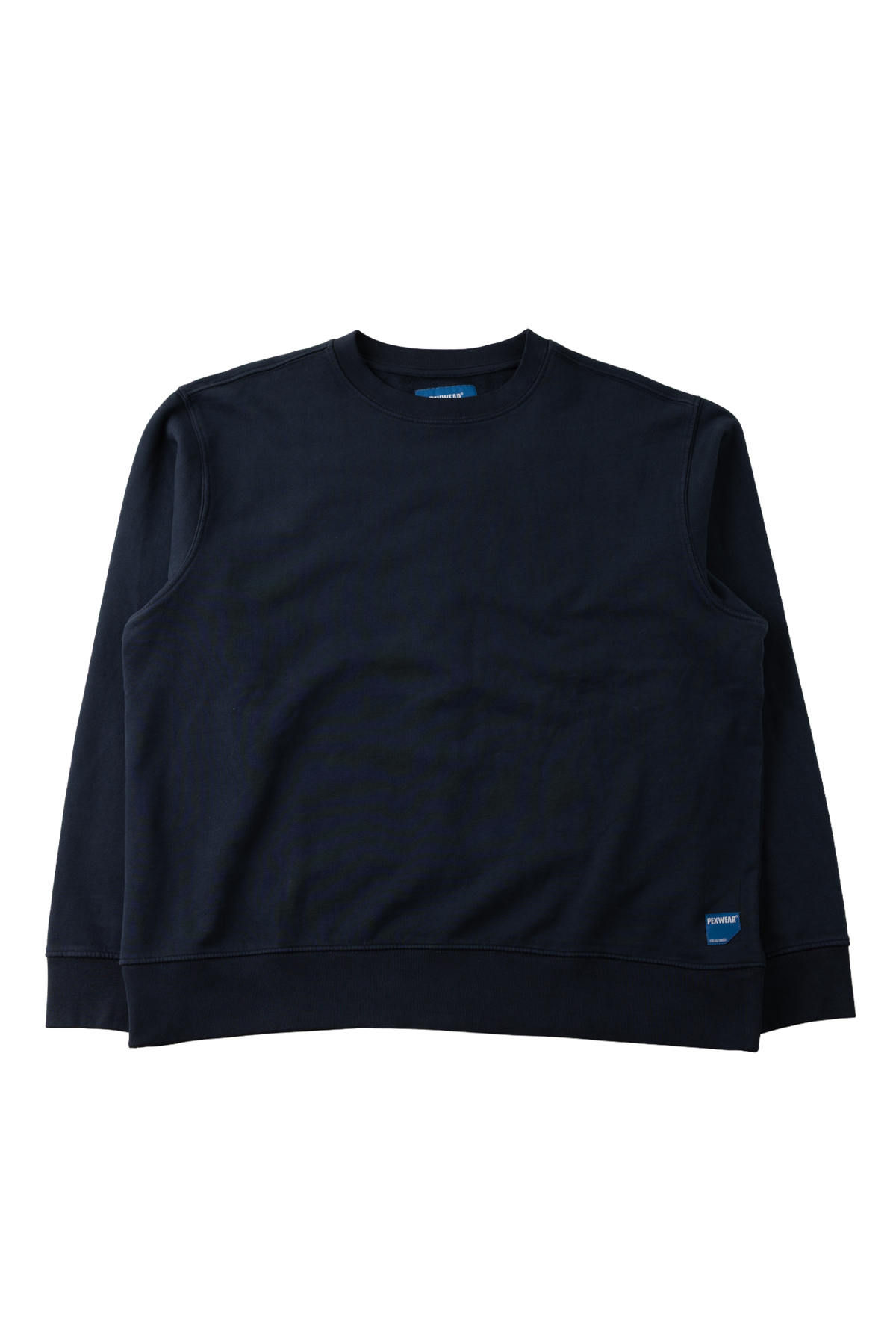 A dark navy blue crewneck sweatshirt with long sleeves, laid flat against a solid white background. A small blue tag is visible on the lower right hem.