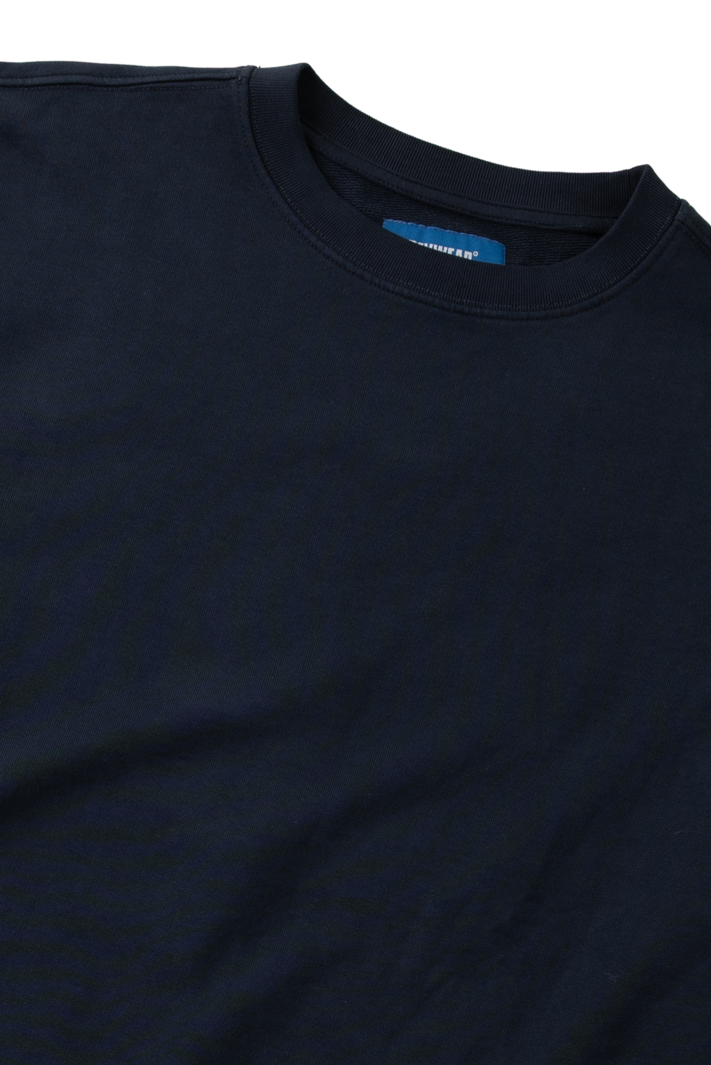 Close-up of a dark navy blue crewneck t-shirt showing the inner collar label which reads 'Comfort Colors'.