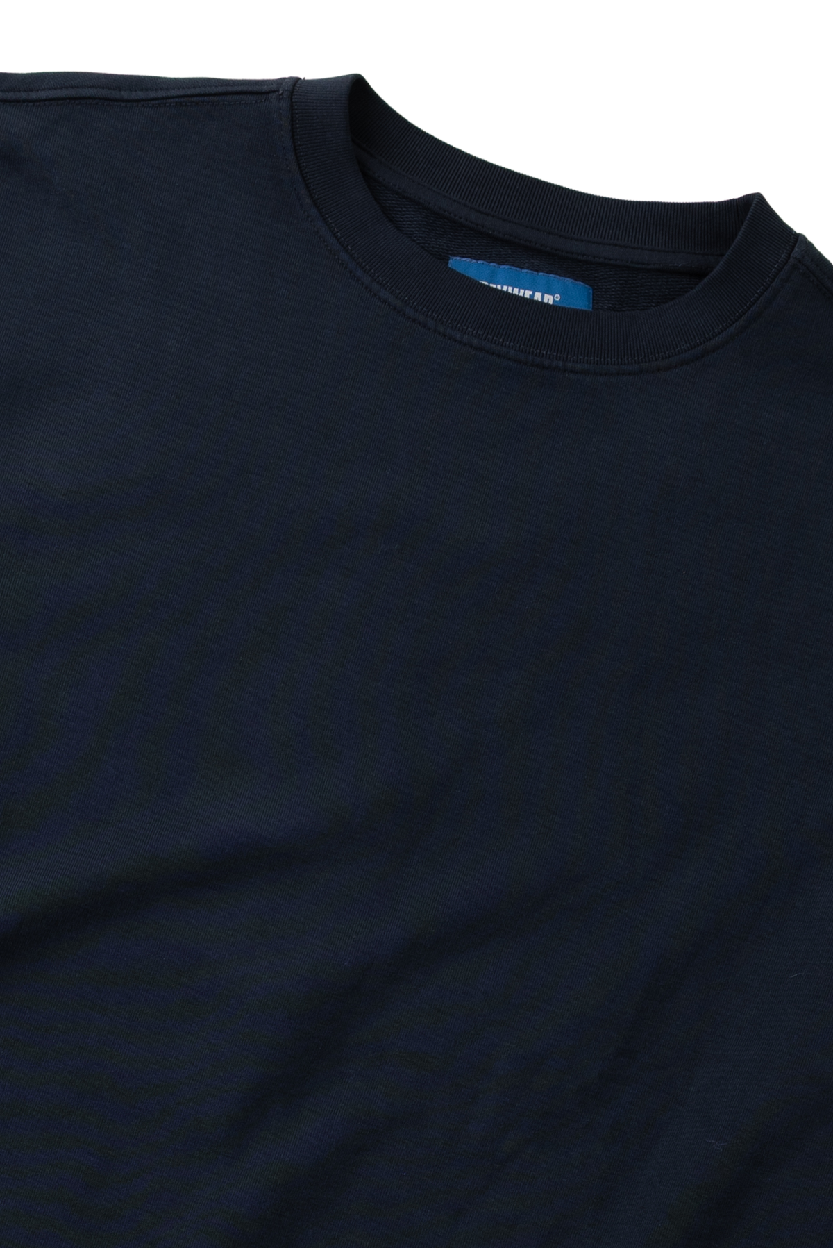 Close-up of a dark navy blue crewneck t-shirt showing the inner collar label which reads 'Comfort Colors'.