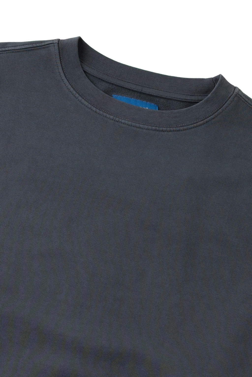 Close-up of a dark charcoal gray crewneck t-shirt showing the ribbed collar and a small blue inner neck label, set against a plain white background.