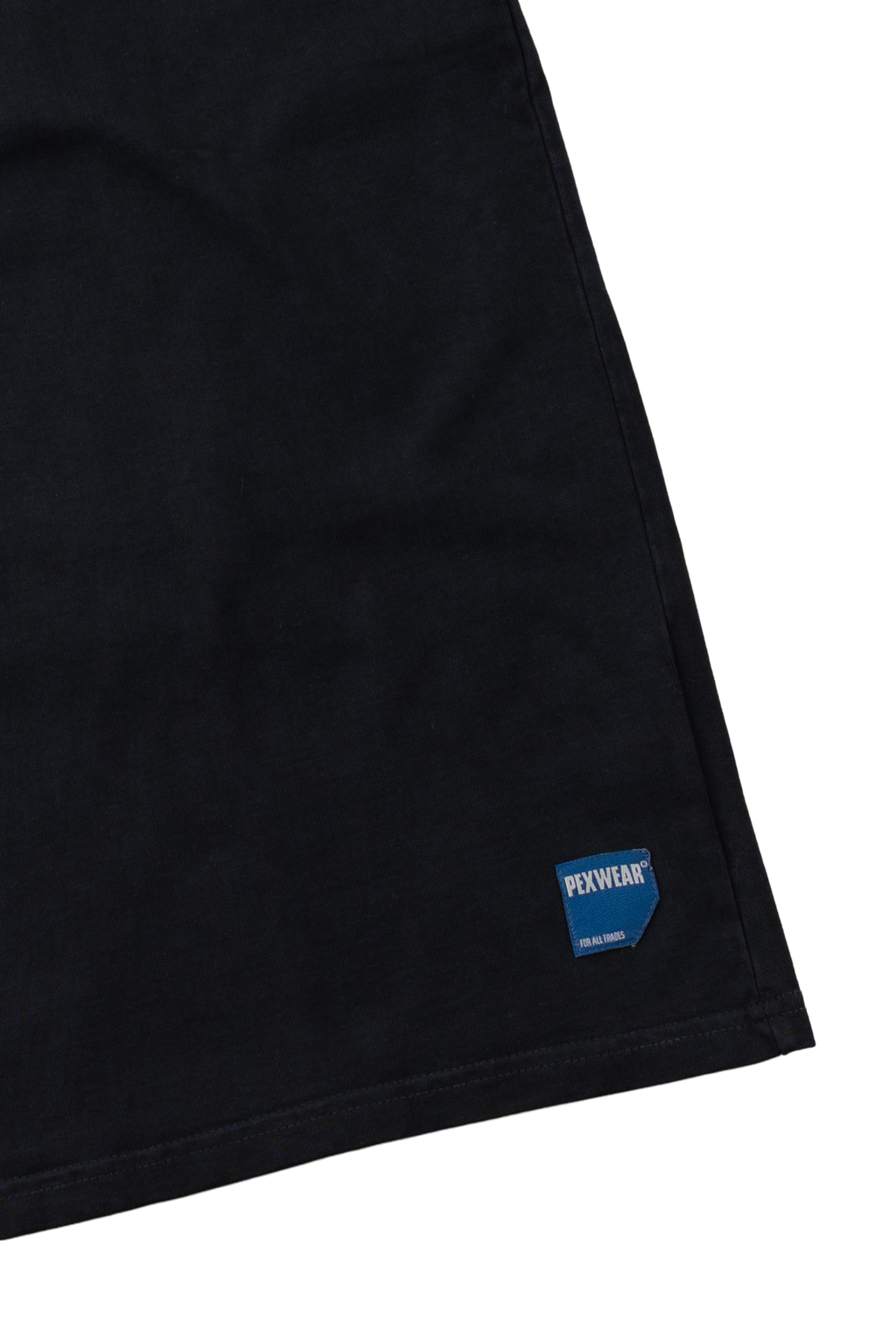 Close-up of a black garment corner with a small blue and white FENWEAR logo patch near the hem, shown against a white background.