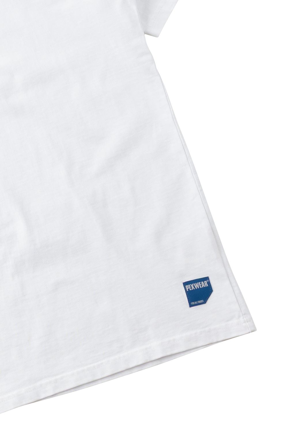 Close-up of a white cotton T-shirt corner with a small blue rectangular Fuxible logo patch near the hem, on a white background.